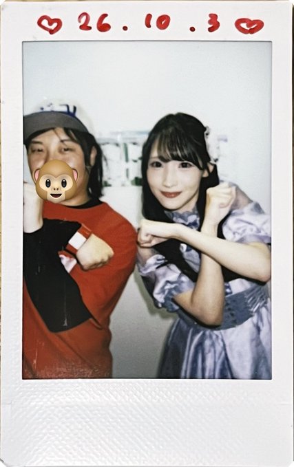 A polaroid-style photo dated '26.10.3' shows two people posing; one person's face is obscured by a monkey emoji sticker, while the woman on the right wears a light purple dress and flexes her arm.