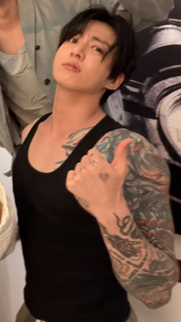 DeanEverAfter's tweet photo. That's my husband, your honour 🥰💘 aka, Jungkook not caring about anyone's sanity.. again 🤣 Something something, why so husband, in his tanktop and sweatpants and fluffy hair and tattoos out, when he doesn't know he's my husband yet, etc. https://t.co/QW5ZSlPmXa