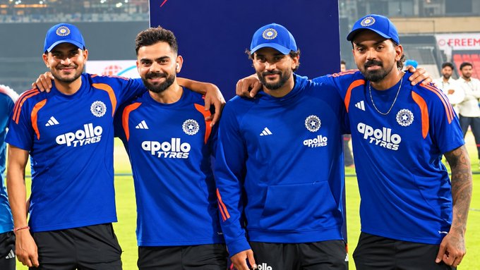 Four members of the Indian cricket team pose together in blue 'apollo TYRES' sponsored training jerseys and caps, including Rohit Sharma, Kohli, and Pant.