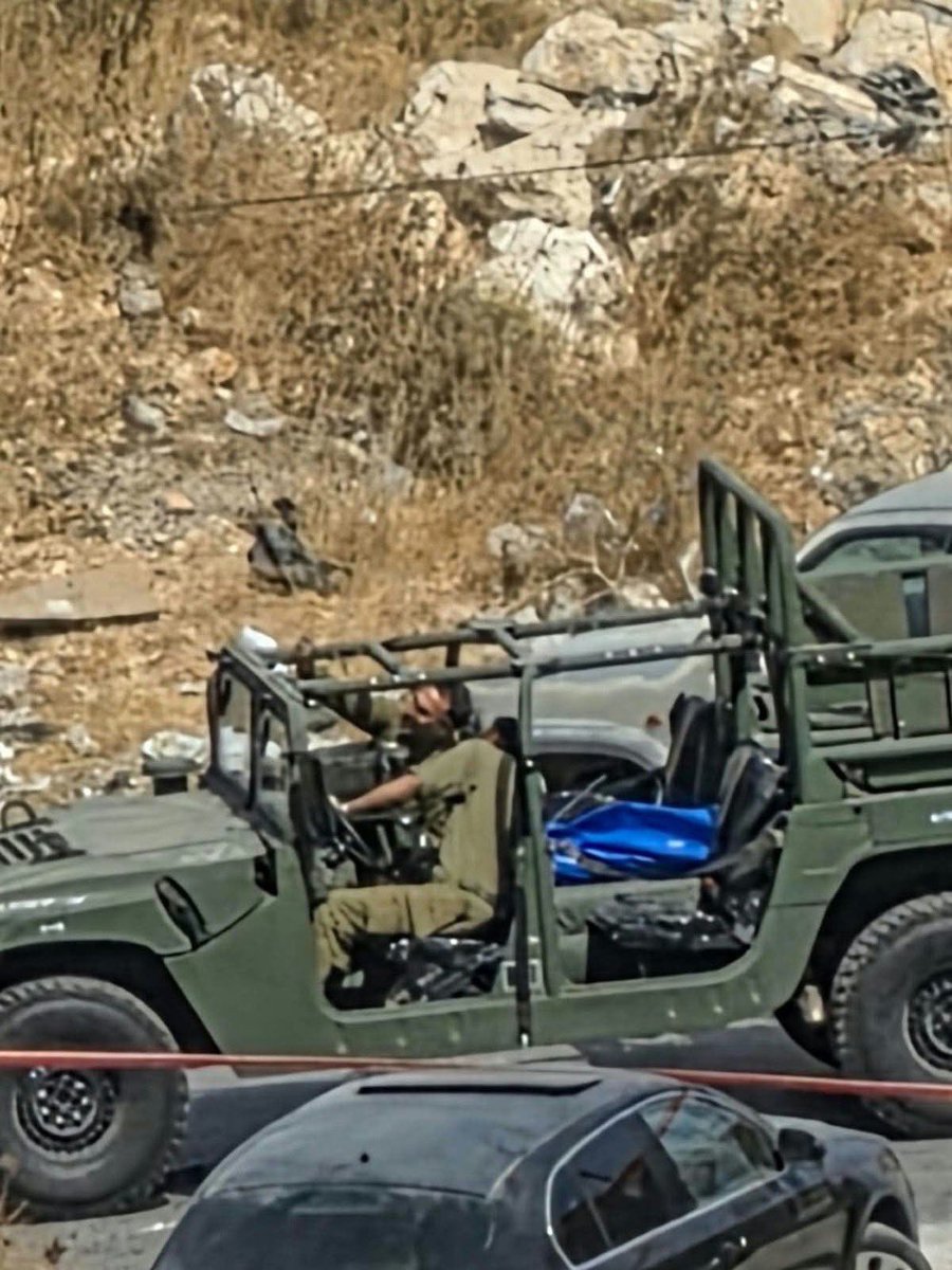 warfareanalysis's tweet photo. ⚡️Update: 

One of the 3 wounded Palestinians inside the vehicle that Israeli army soldiers opened fire on at the entrance to Bani Naim, east of al-Khalil, and prevented ambulances from reaching them, has died.

His name is Mahmoud Hani Idais, 41, from Yatta.(photo 1) 

An Israeli army soldier took a selfie with his body. (Photo 2)