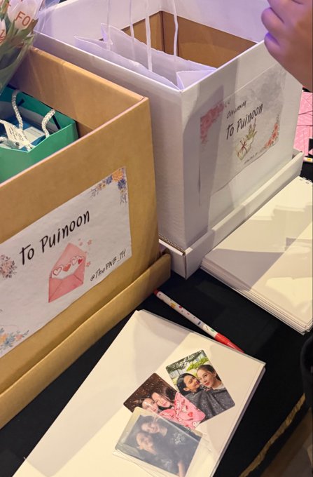 Brown paper shopping bags labeled 'To Puimoon' by ไหมพรม sit on a table alongside polaroid photos and a pencil.