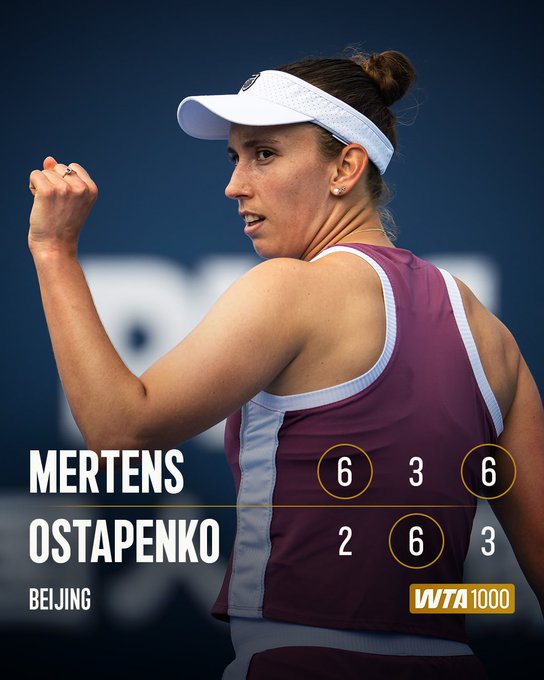 The image shows tennis player Elise Mertens in a white visor and maroon athletic top, raising her fist in celebration after her 6-3, 2-6, 6-3 victory over Ostapenko at the Beijing WTA 1000 China Open, advancing her to the Round of 16 for the first time.