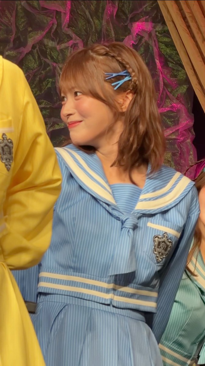 A young woman with short brown hair and a braided side section smiles softly to the side, wearing a light blue sailor-style uniform with cream trim and an emblem, and two blue hair clips. The "LOVE" badge and idol-like aesthetic complement the post's affectionate caption calling her "cute" alongside the hashtag #江角怜音 (Esumi Reon).