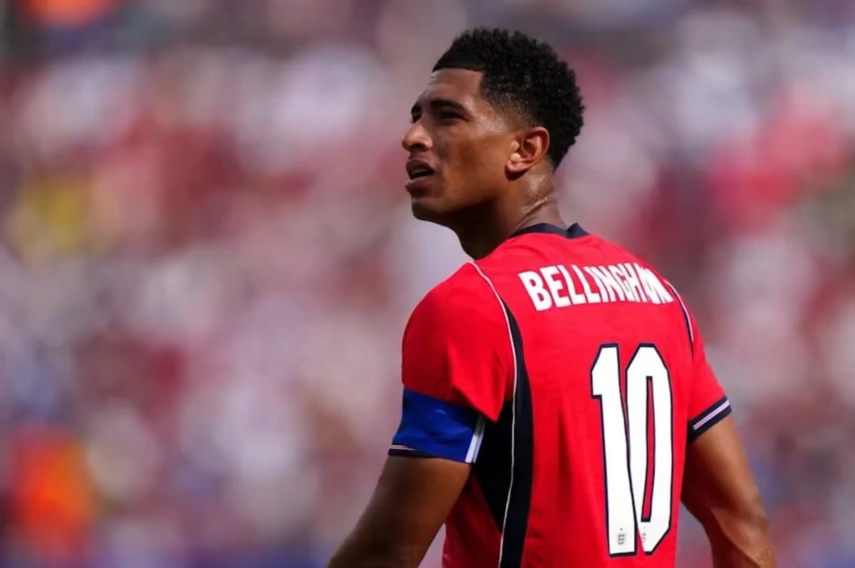 Jude Bellingham is pictured from behind wearing a red jersey with 'BELLINGHAM' and the number '10' printed on it.