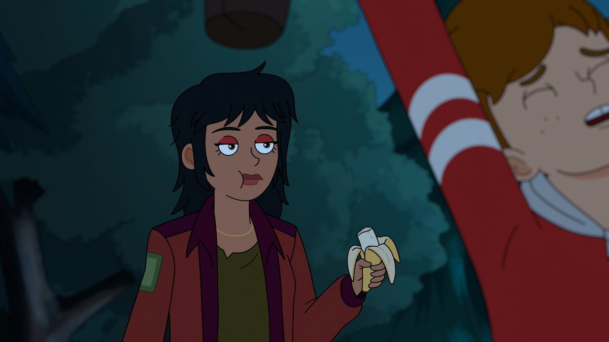 A dark-haired woman in a red jacket holds a peeled banana while making a skeptical face at a freckled boy in a striped shirt who appears distressed, in an animated nighttime scene that serves as a preview for the new season of "Haunted Hotel."