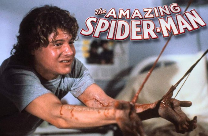 A still from 'The Amazing Spider-Man' showing a man with curly hair grimacing, his hands covered in webbing and blood, with the film's title logo in the corner.