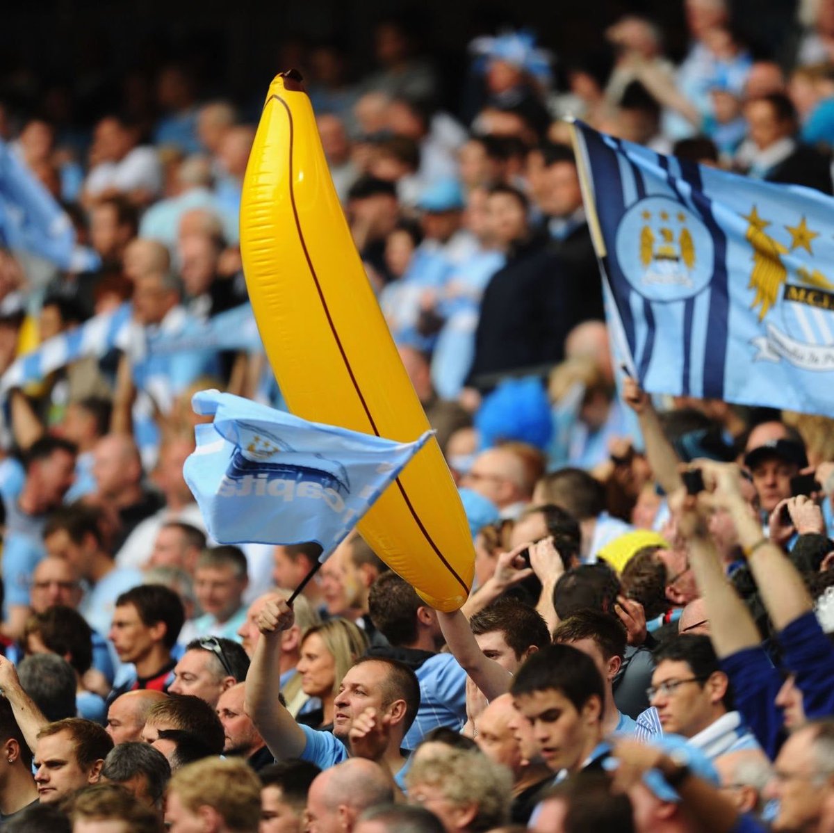 city_exclusives's tweet photo. Travelling Manchester City fans have placed bulk orders for inflatable bananas ahead of the Liverpool match, framing the display as a celebration of club history and a show of support after the committee ruling. Reviving a tradition that began at Maine Road in 1987. 

[via @ManCityMEN ]