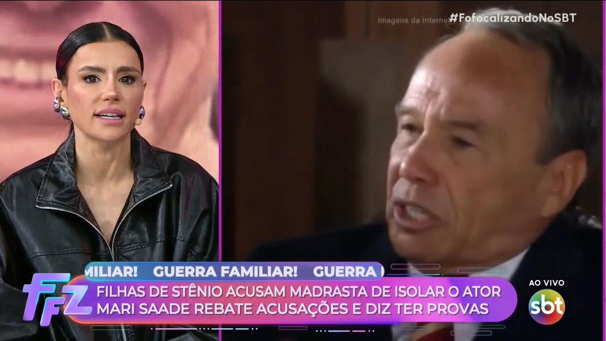 A split-screen broadcast from SBT with the hashtag '#FofocalizandoNoSBT', showing a woman in a black leather jacket on the left and a man speaking on the right, with a Portuguese news ticker reading 'MILIONÁRIOS! GUERRA FAMILIAR! GUERRA' and 'FILHAS DE STÊNIO ACUSAM MADRASTA DE ISOLAR O ATOR MARI SAADE REBATE ACUSAÇÕES E DIZ TER PROVAS'.