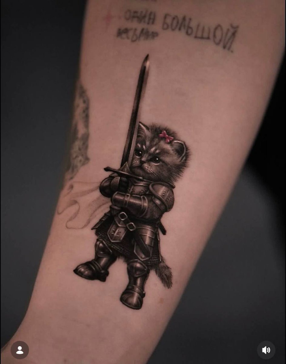 catlerone's tweet photo. Swordcat really went from a random AI meme to an actual tattoo.

People are literally putting this little armored cat on their skin now 😭

A few weeks ago it was just another viral AI character.

Now people are getting emotionally attached enough to make it permanent.

AI memes move fucking fast.