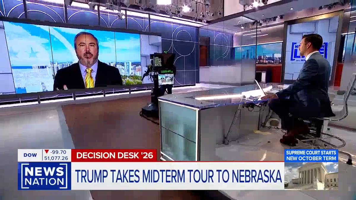 A NewsNation broadcast titled "Decision Desk '26" features an in-studio anchor interviewing a remote guest, identified by the chyron as the RNC Chair discussing Trump's midterm tour in Nebraska, while the Dow ticker shows a 99.70 drop to 51,077.26 and a sidebar notes the Supreme Court starting its new October term. The setup visually anchors the accompanying post about Trump's efforts on behalf of American workers and the economy, showing the political commentary in context.