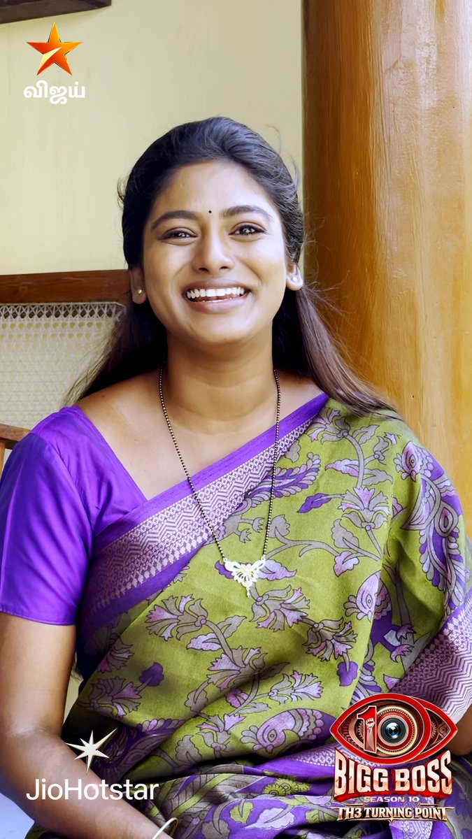 A smiling woman in a green and purple floral saree appears in a promotional image for Bigg Boss Tamil Season 10, featuring logos for Vijay TV, JioHotstar, and the show's branding. The post suggests the image is a behind-the-scenes look teasing upcoming twists and turns in the season, hosted by Vijay Sethupathi.