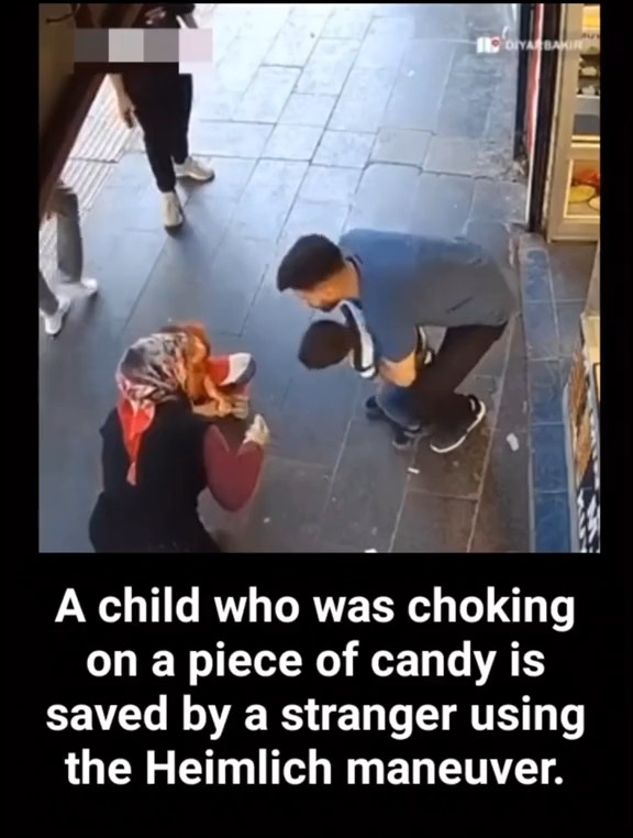 A surveillance-style video still shows a man performing the Heimlich maneuver on a choking child, with the caption 'A child who was choking on a piece of candy is saved by a stranger using the Heimlich maneuver.' and the watermark 'HD ORYASAM HABER'.