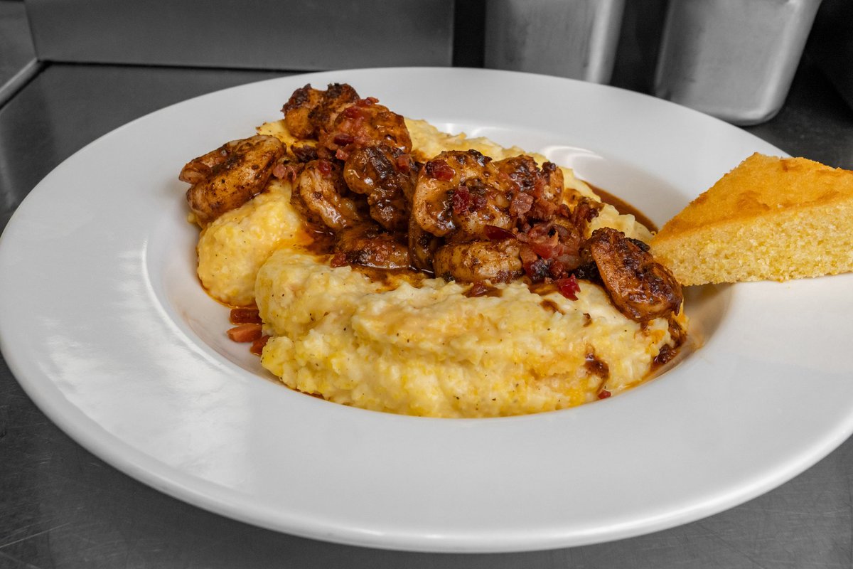 Taytros's tweet photo. Shrimp and Grits brings the comfort: homestyle cheesy grits loaded with sauteed shrimp and bacon pieces for a rich, satisfying bite 🍤🧀 Plan your next stop at Taytro's Bar &amp; Bistro and come say hello. #TaytrosBarAndBistro #ShrimpAndGrits #CajunCreole https://t.co/b7lZT3cFBO