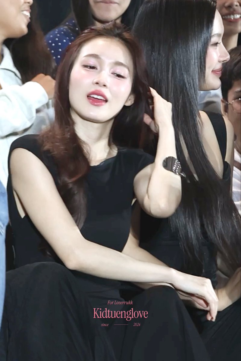 A fan-edited photo of two young women in black outfits seated together at an event, with pink text at the bottom reading 'For Loverrukk Kidtuenglove since 2024'.