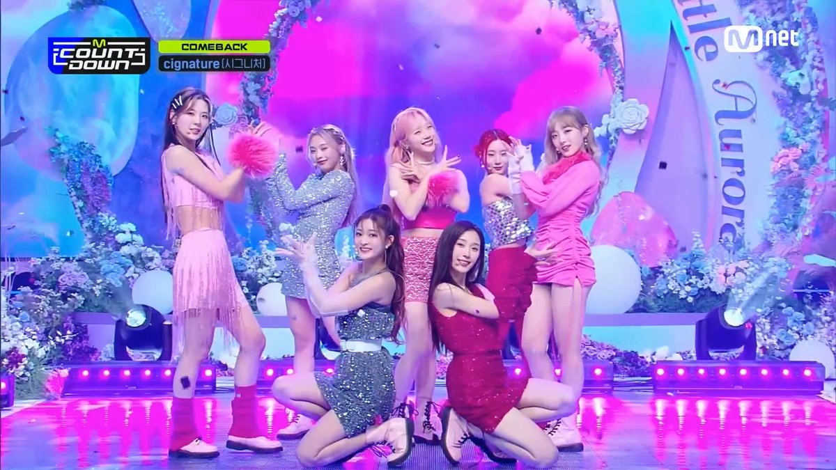 K-pop group cignature performing on Mnet's M Countdown, with on-screen text indicating 'COMEBACK' and 'cignature'.