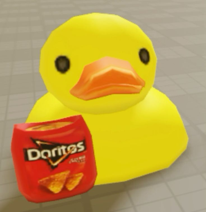 A 3D-modeled yellow duck sits on the floor holding a red bag of Doritos chips in its wing.