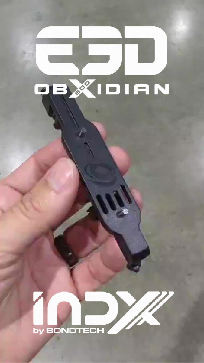 A hand holds a black mechanical component, with overlaid text reading 'E3D OBXidian' and 'INDEX by BondTech'.