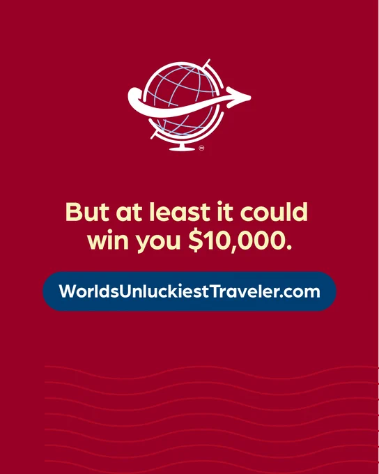 Text: "But at least it could win you $10,000. WorldsUnluckiestTraveler.com"
