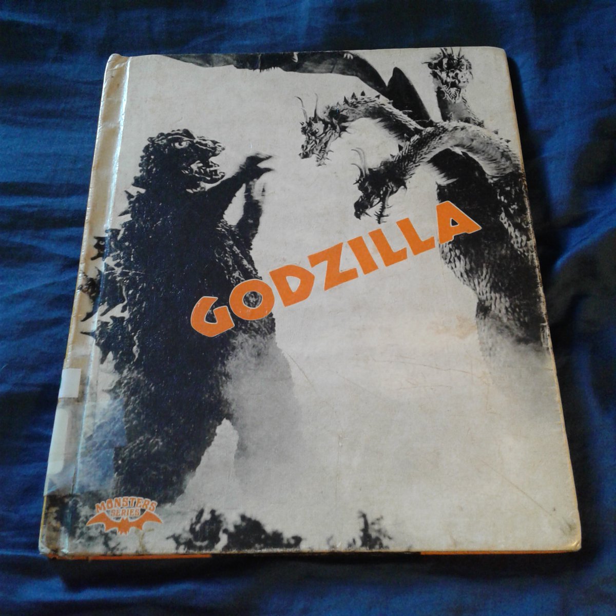 JamesGChampagne's tweet photo. Currently Reading: GODZILLA by Ian Thorne

This is actually a reread. I never had this book as a child, but my grade school library had it, and it was one of my favorite books to check out. It was part of the Movie Monster series published by Crestwood House, which apparently were quite popular with school libraries in general in the late 1970s/1980s. Most of them were written by Julian May (under the name Ian Thorne), and I also enjoyed her books on King Kong, Dracula, The Blob, and divers others. I finally got my own copy off eBay some years ago (according to the circulation card on the inside cover, its former home was a library in Ohio), but I'm only just now rereading it. These books were very informative and featured great picture selections.

I've been a Godzilla fan since as long as I can remember. Along with Lewis Carroll's Alice, he's one of my first and oldest friends.