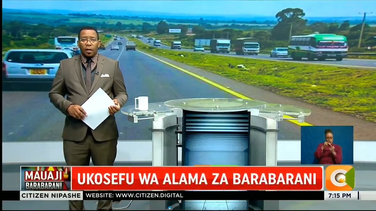 A news presenter in a tan suit stands at a podium holding handwritten scripts during the "Mauaji Barabarani" segment on Citizen TV's Citizen Nipashe at 7:15 PM, with the headline "UKOSEFU WA ALAMA ZA BARABARANI" displayed on the lower third. A sign language interpreter appears in the corner while the backdrop shows a busy highway with vehicles, fitting the story about missing road signs.