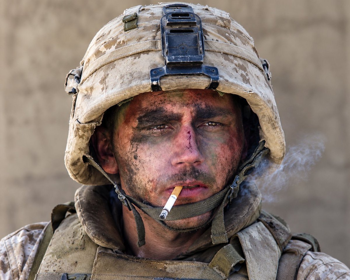 specialopsmag's tweet photo. The famous "Marlboro Marine" photo of Lance Cpl. James Blake on November 9, 2004, in the middle of the Second Battle of Fallujah.

Los Angeles Times photographer Luis Sinco raised his camera and caught the 20-year-old Marine leaning against a wall with a cigarette hanging from his mouth. 

Miller, of Charlie Company, 1st Battalion, 8th Marines, had spent the night pinned down under fire, with blood running from his ear and the bridge of his nose, dirt and paint smeared across his face, and momentarily deaf from a tank blast. 

Sinco later said the look said everything: terrified, exhausted, and glad just to be alive. The photo ran in more than a hundred newspapers, and Dan Rather even singled it out on the evening news. 

Embarrassed by the fame, Miller asked a reporter to tell Marlboro he was down to four packs, and then went back to the fight.