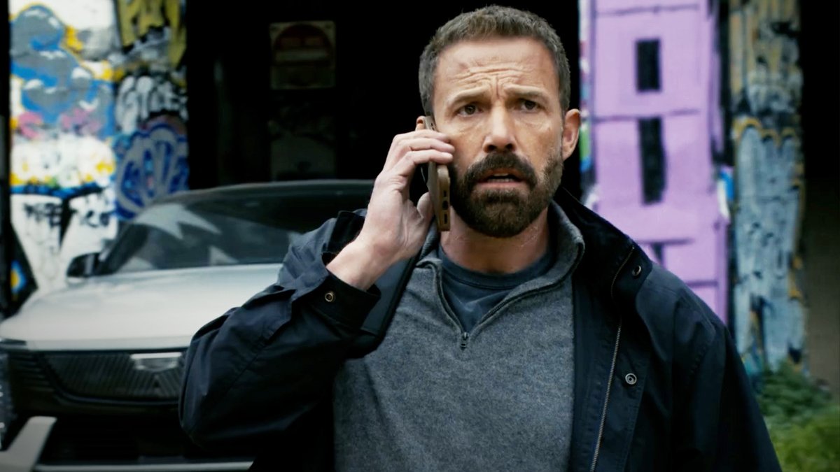 Ben Affleck holds a phone to his ear with a concerned expression, standing in front of a white car against a graffiti-covered wall, likely a scene from the upcoming Netflix thriller "Animals."