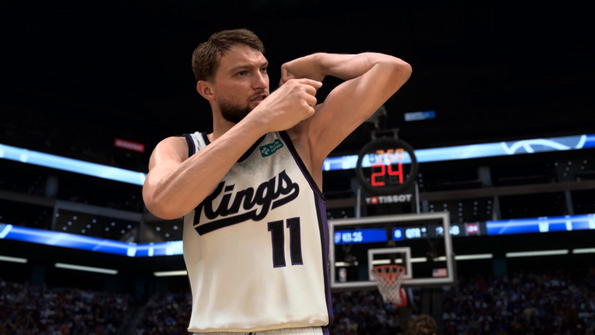 A Sacramento Kings basketball player wearing jersey number 11 stands on the court making a hand gesture near his face, with a shot clock displaying 24 visible in the background.