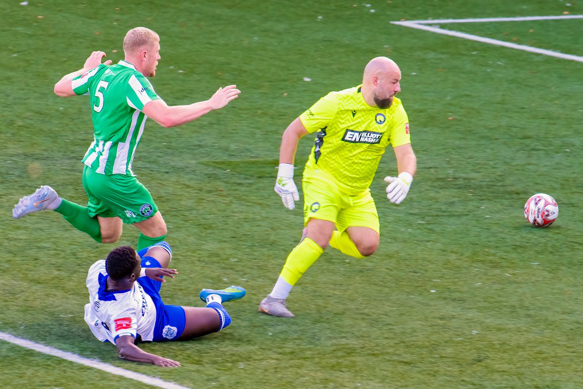 GomboczSteve's tweet photo. Some more player action photos taken during the game between Bury v Bromsgrove on 3/10/26. In one photo Mo Touray slides the ball past the goalkeeper for the 2nd goal. @buryfcofficial #bfc140 #shaker #BuryFC #PartOfit @whitebluearmy https://t.co/xYxcYK4UVK
