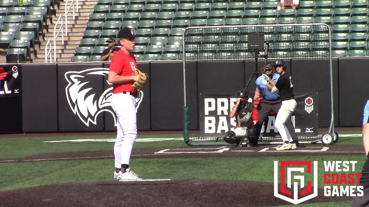 A baseball game in progress, showing a pitcher in a red jersey on the mound, with a batter, catcher, and umpire at home plate; the background features a "PREP BASEBALL" banner and a "WEST COAST GAMES" logo.