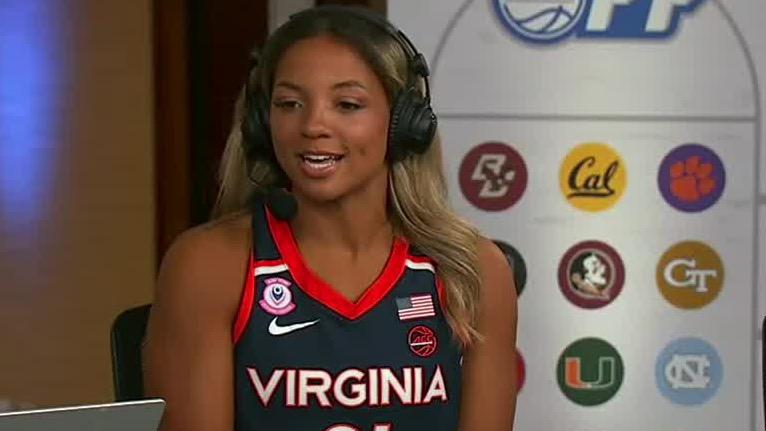 A young woman wearing a Virginia basketball jersey and headphones speaks in what appears to be an ACC Network interview setting.