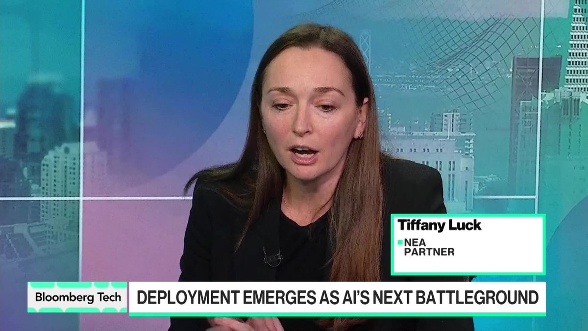 Tiffany Luck, NEA Partner, appears on Bloomberg Tech discussing how AI deployment—not just model development—is the next major battleground for enterprise returns. The on-screen chyron "DEPLOYMENT EMERGES AS AI'S NEXT BATTLEGROUND" reinforces her point that turning powerful models into real-world ROI represents the industry's next big opportunity.