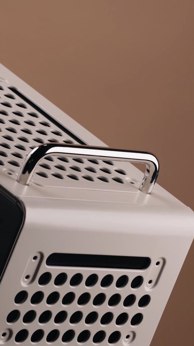 A close-up of the top of a white QUBE 540 PC case featuring a chrome handle and perforated ventilation grilles, showcasing the 3D-printed design that the post highlights as customizable through its ecosystem of printable accessories.
