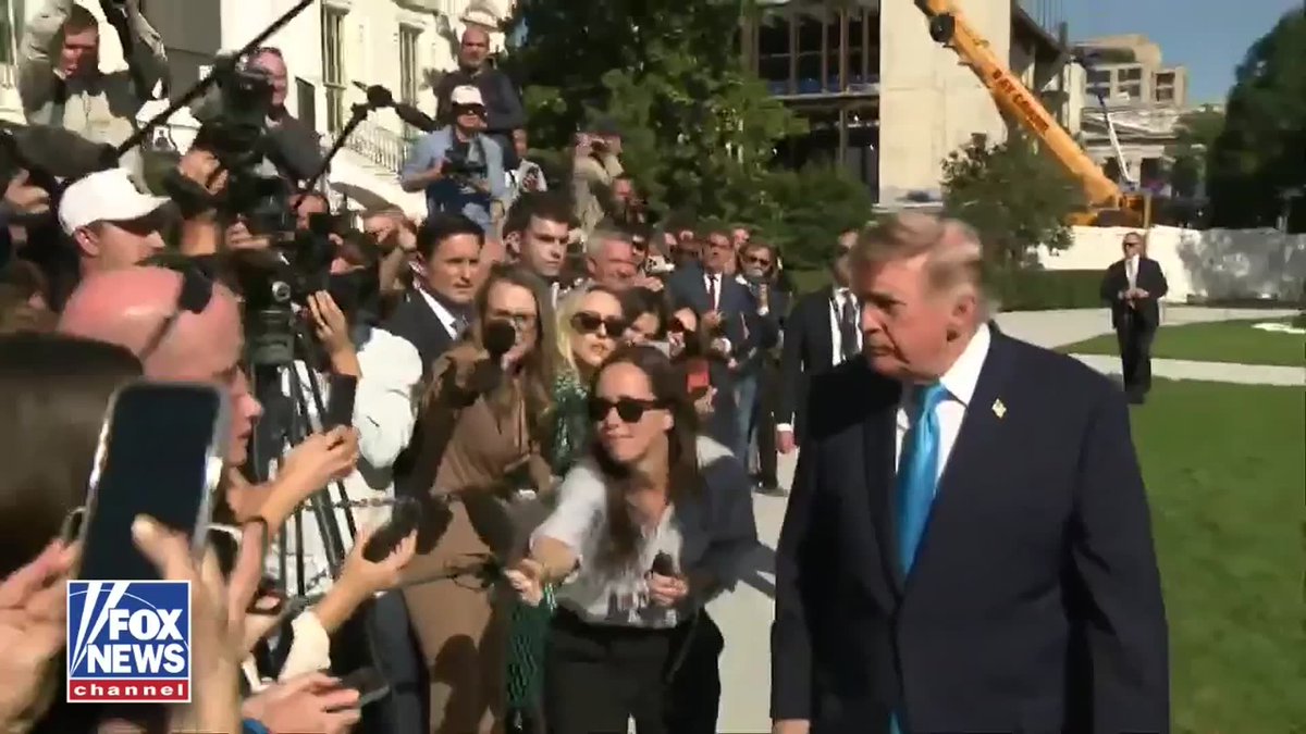 A Fox News screenshot shows President Trump, wearing a dark suit, addressing a crowd of reporters and onlookers holding microphones, cameras, and smartphones outside a building, with the "FOX NEWS channel" logo visible in the lower-left corner. The image accompanies his statement about the U.S. being prepared to assist Russia with a suspected plague case.