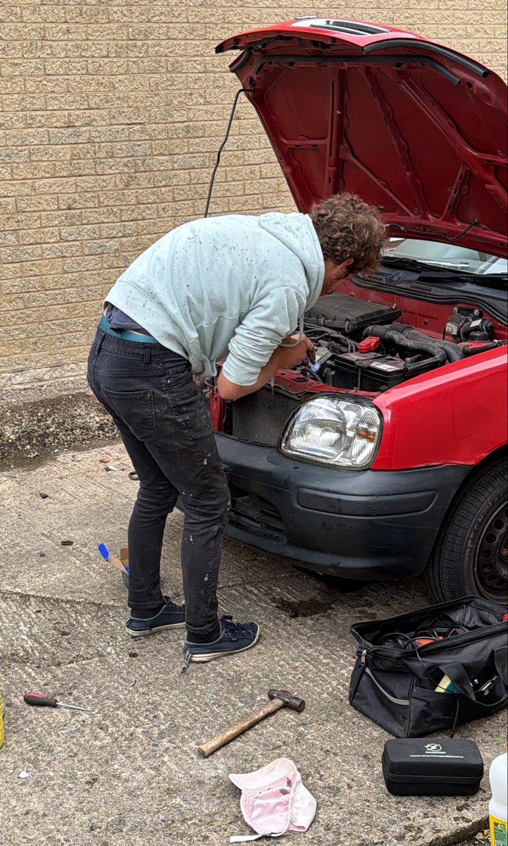 ThreadofGold1's tweet photo. Bram working on his very ancient Micra. He would argue strongly that it’s a small beauty. 
I am amazed at his mechanical skills: I have absolutely no technical ability at all. 
#SmallBeautiesHour
#BecauseOfClem #ThreadOfGold💛 https://t.co/EpvFt4OqiG