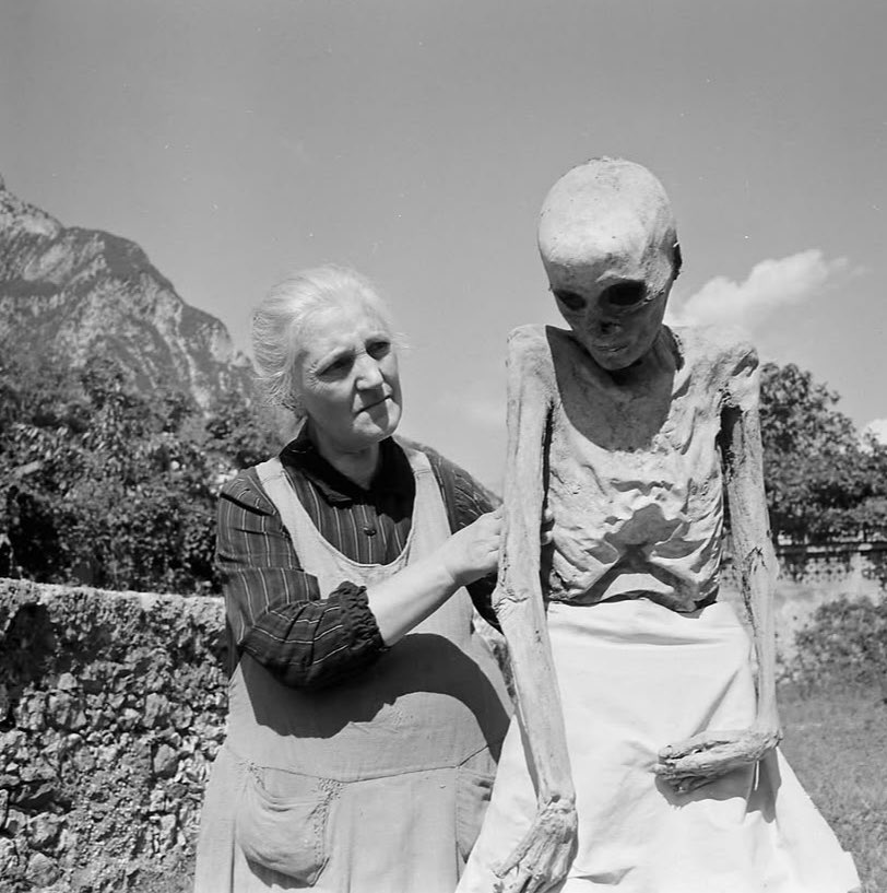 sonnysehra's tweet photo. in 1950, a photographer lost in the alps needed a place to stay for the night and found a rural italian commune, where he saw an old man drinking tea with a mummy. the corpses were from the plague, locals believing it was god’s will for their ancestors to protect the village. https://t.co/TLInAiM8Go