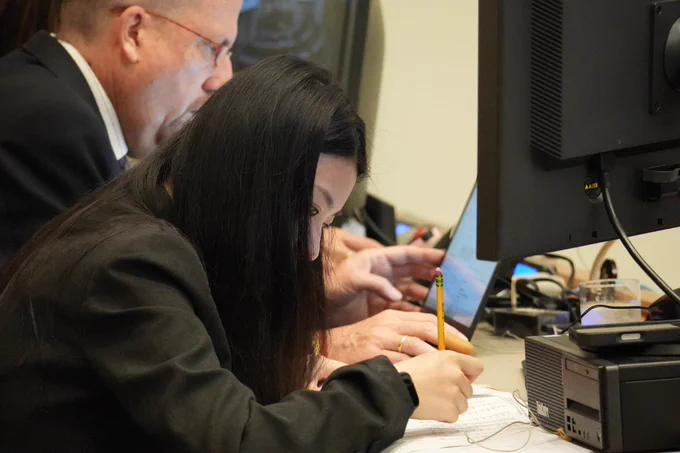 DGACM staff members review documents before a Second Committee meeting at UN Headquarters.