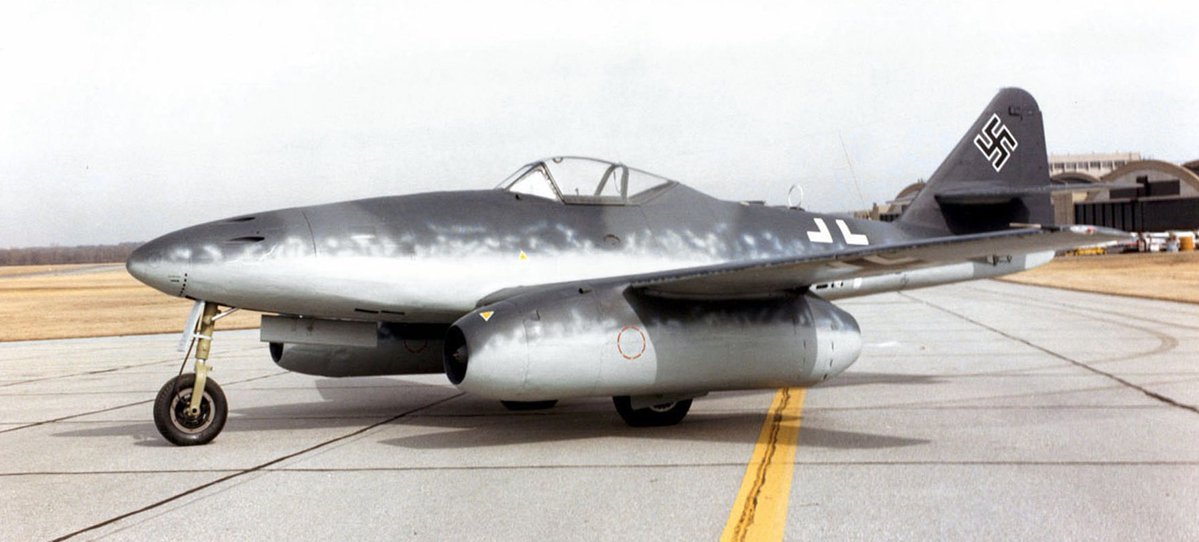 VoicesofWW2's tweet photo. October 5, 1944. Over Nijmegen in the Netherlands, a flight of Canadian Spitfires spots something new in the sky: a German Me 262 jet.

The Me 262 was the first operational jet fighter in history. It was more than 100 miles per hour faster than anything the Allies had. On paper, a Spitfire had no business catching it.

But jets had weaknesses. They were slow to accelerate, burned through fuel, and their pilots often had to dive and twist to get away.

Pilots of No. 401 Squadron, Royal Canadian Air Force, piled onto the jet as it maneuvered. Several of them took shots. The Me 262 was hit, trailed smoke, and went down.

It was the first German jet destroyed by Commonwealth fighter pilots.

The Germans built more than 1,400 Me 262s before the war ended. It came too late and in too few numbers to change anything, but for Allied pilots, the jet age had officially begun.