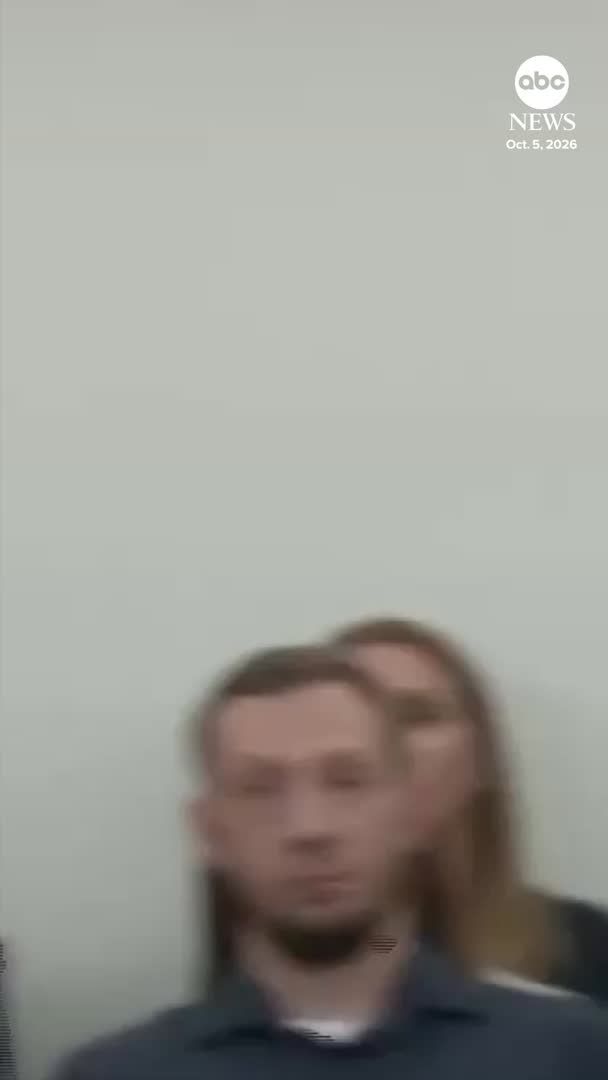 A blurry image shows a man with a beard standing in front of another person, with an "abc NEWS" logo and the date "Oct. 5, 2026" in the top right corner.