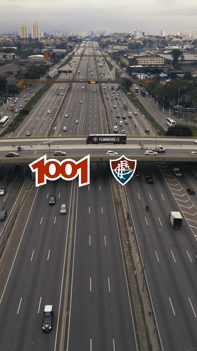The image shows an aerial view of a multi-lane highway with a double-decker "Fluminense FC" team bus crossing overpass, featuring the "1001" logo and Fluminense's crest prominently displayed. The branding highlights the renewed partnership between Fluminense FC and the 1001 company, marking the unveiling of their new double-decker team bus.