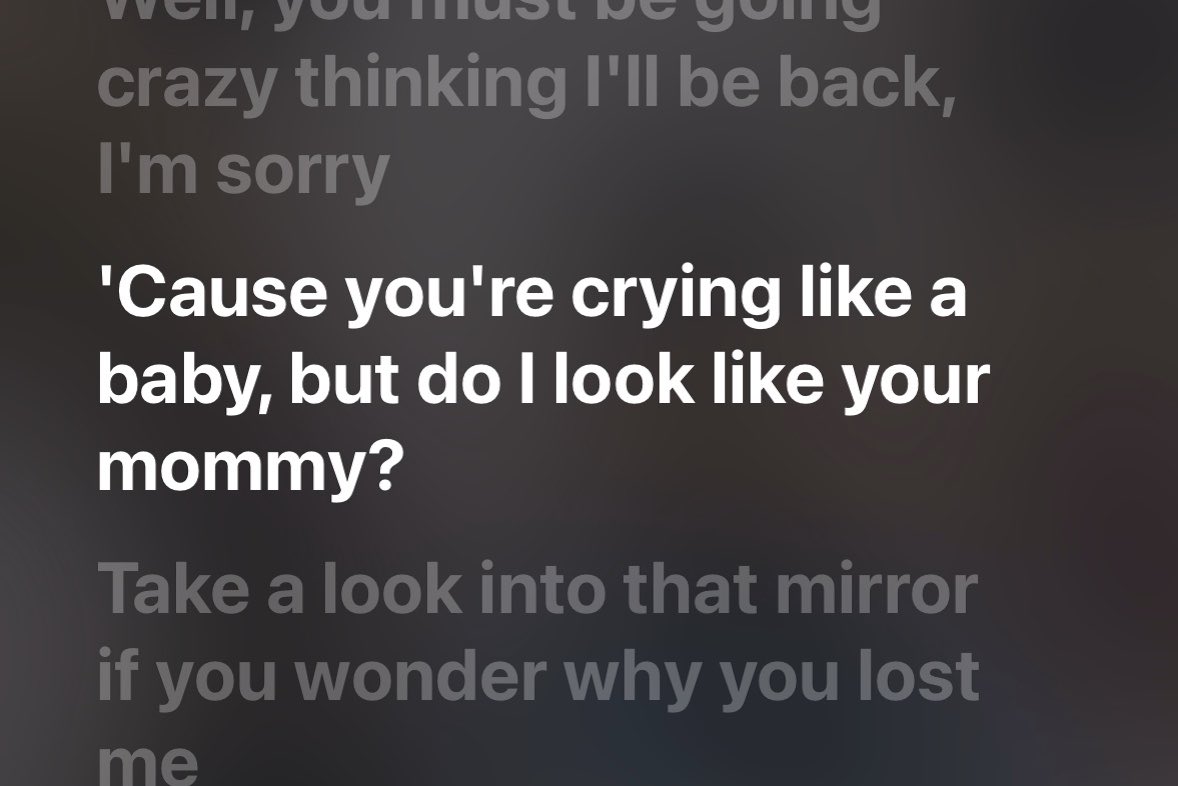 Song lyrics are displayed on a dark background with the highlighted line: ''Cause you're crying like a baby, but do I look like your mommy?'