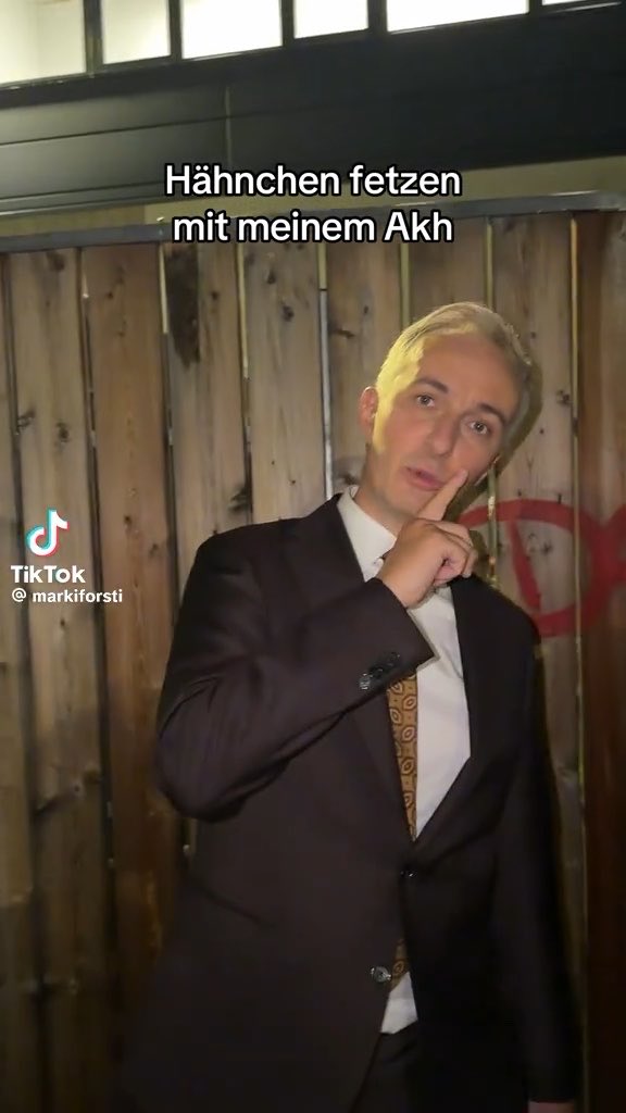 A TikTok screenshot from @markiforsti shows a man in a dark suit and patterned tie touching his chin thoughtfully, with German text overlay reading "Hähnchen fetzen mit meinem Akh."