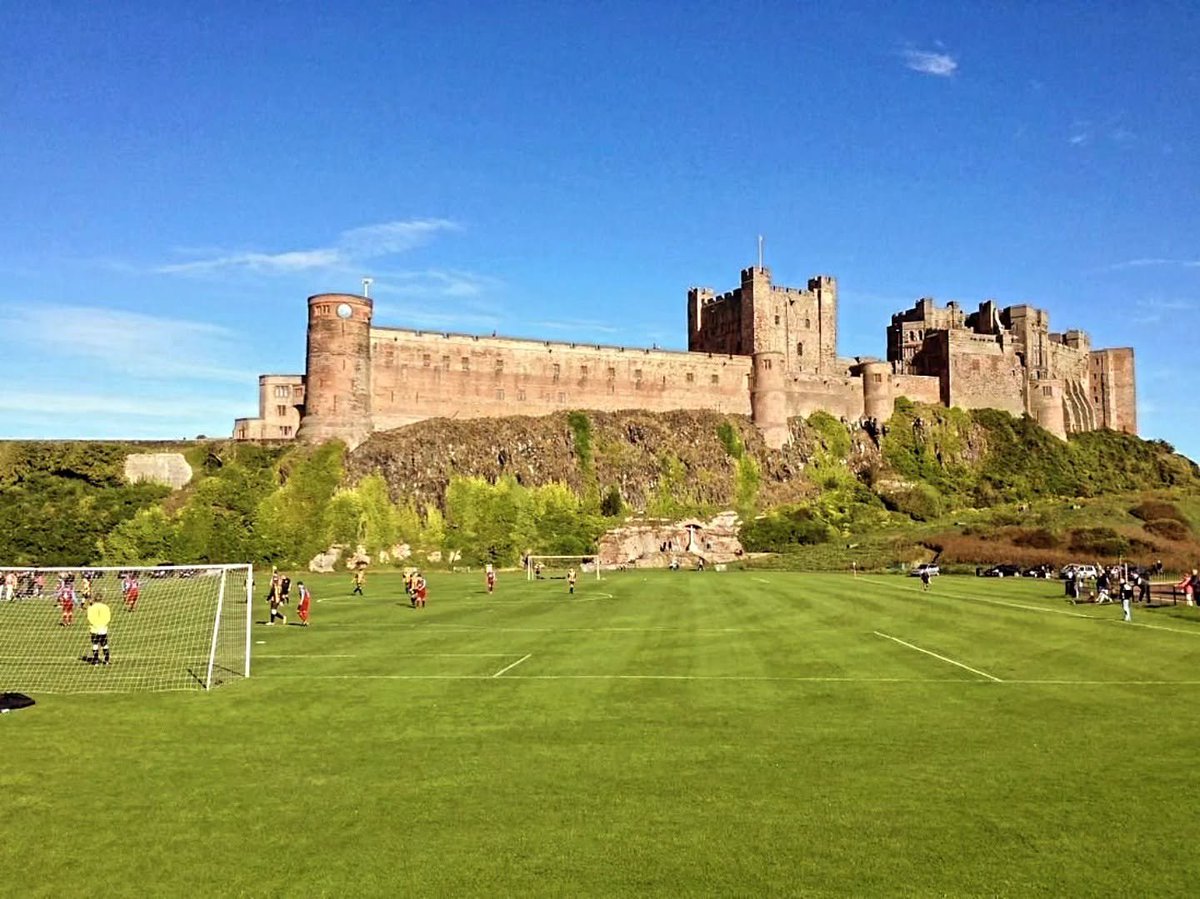 theawayfans's tweet photo. A football pitch sitting beneath Bamburgh Castle in Northumberland. 🏰⚽

Not a bad backdrop for a game. https://t.co/HBx4ALeFr0