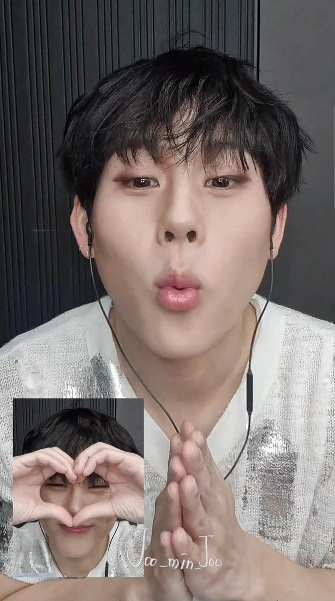 A video still of Jungkook (Joo_min_Joo watermark) in a sparkly silver top with earphones, making a kissy face, with a smaller inset image of him making a heart shape with his hands.