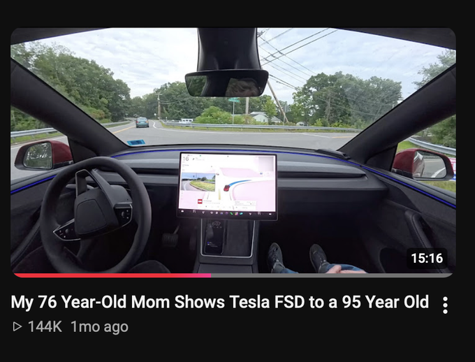 A YouTube video thumbnail titled "My 76 Year-Old Mom Shows Tesla FSD to a 95 Year Old" displays a first-person view from inside a Tesla, showing the steering wheel and center console with a navigation screen, while driving on a road at 15:16. The image illustrates the post's theme of showcasing Tesla's Full Self-Driving technology to skeptical or older viewers, reinforcing the idea that firsthand experience with Tesla's advanced features can change minds about the brand.