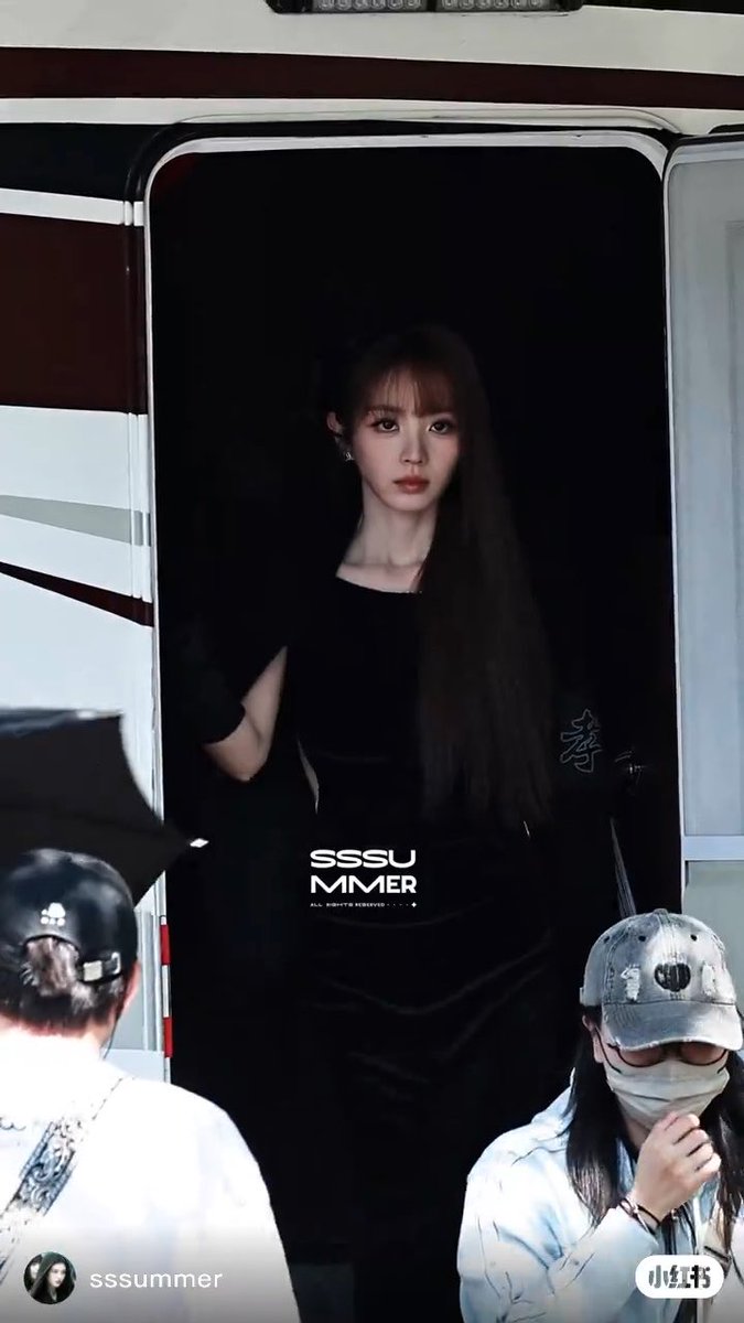 The image shows a young woman with long dark hair wearing a black top standing in the doorway of a vehicle, with the watermark 'sssummer' visible on the photo.