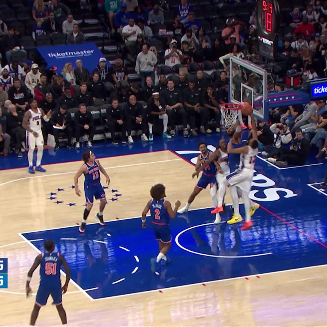 Drummond (#5) blocks a shot attempt near the rim during a Sixers game against the Clippers at 9:14 in the quarter, with the Ticketmaster and Tissot advertisements visible courtside, showcasing the dominant defensive play referenced in the caption.