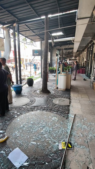 Shattered glass litters the walkway at the San Antonio Shophouse Complex in Pakuwon City, Surabaya, where an LPG cylinder blast damaged dozens of shophouses, several vehicles, and injured two employees.