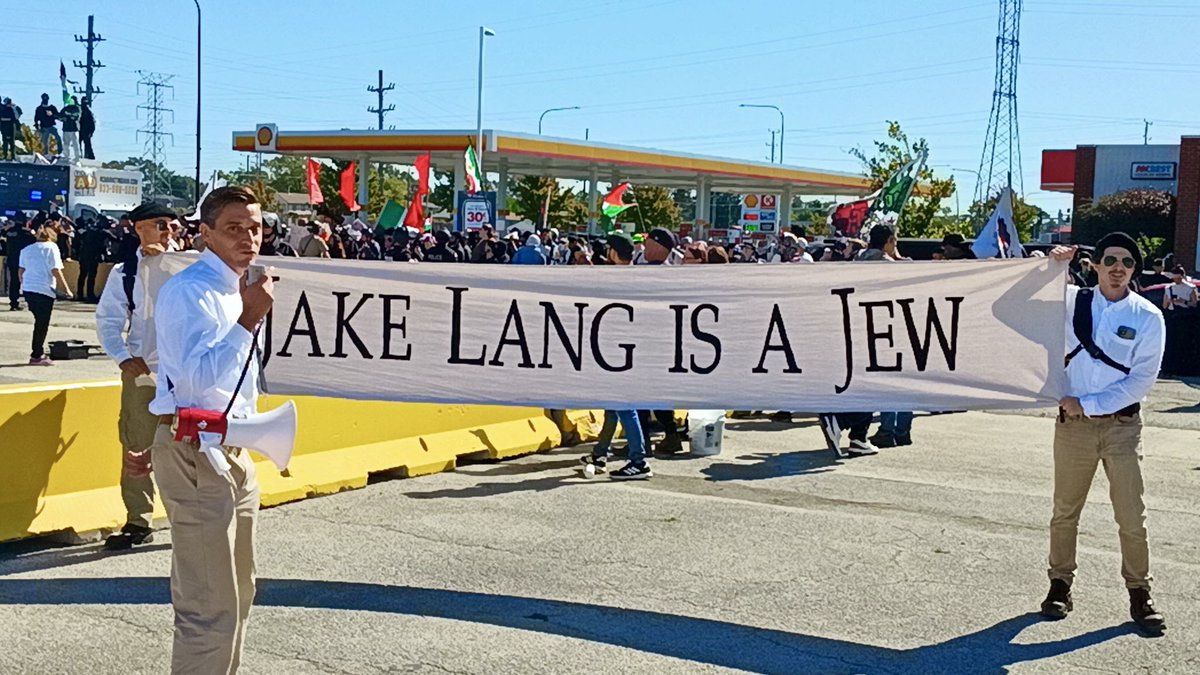 EVROP_AESTHETIC's tweet photo. Jake Lang is a Jew. He’s a Zionist operative who leverages White grievances from Muslim immigration to fuel more Jewish war in the Middle East. He also co-opts awakening White racial energies into dead or Jewish ends.

It’s not a coincidence that Lang chose Little PALESTINE in Bridgeview, Illinois outside Chicago for his latest Zionist op. Of course, it accomplishes old-fashioned anti-Jihad fervor for wars against Muslims. But to support Lang’s stunt in Little PALESTINE, one must suppress the de-legitimizing evil Israel has done in original PALESTINE that brought these PALESTINIANS here… This Israeli evil contextualizes all ZOG activity in the Middle East, including the ongoing Iran War.

It’s an implicit, last ditch apologetic for Israel before an imminent false flag or other pretense for escalation in the Iran War or elsewhere in the Middle East. Such escalation is to maintain Netanyahu’s incumbency in upcoming Israeli elections on October 27th, or escalate before he’s booted lest they lose the chance.

The anti-war movement in America is ran by Jews. They pollute it with degeneracy that makes red-blooded Whites turn away. They lead it into dead ends, like attribution of the cause of these wars to “oil” rather than Israel.

The anti-war movement must be led by Whites, the people who make wars for Jews possible with our blood! We, the Nazis, are the only real anti-war movement in America because we’re the only ones who know who are behind these wars and what they’re for — Jews and Zionist interest — and we explicitly and fervently state it in the REAL WORLD to REAL PEOPLE, putting ourselves at REAL RISK to do so.

Jews lead the Pro-Palestinian movement in a myriad of organizations using the same tactics that they use to ruin the anti-war movement. Such as attributing causes to dead-ends like colonialism, or to blame their heinous actions in Palestine on Whites by claiming it’s “white supremacy” rather than the reality of Jewish supremacy! The Pro-Palestinian movement must be led by Palestinians and Arabs, not Jews. 

We, the Nazis, are also the only real representatives of our collective White Race. We realize the full extent of the Jewish problem, including that Jews leverage our own racial grievances to make enemies of us with anti-White hatred, and enemies of their other enemies, like White hatred of Arabs or Muslims! We are the real White representatives because we don’t fall for Jews’ demographic traps, be it Jang Lang, or what so many in the so-called White Nationalist movement fall for. These White Nationalists believe every brown person is their enemy with no ability to politically focus on the source of and solve the demographic problem they oppose — Jews!

We, the Nazis, as the legitimate representatives of the American anti-war movement and of the White Race’s interest, are eager to engage Palestinians, Arabs, and Muslims to respectfully work toward a goal we both share: Overcoming Jews. The defeat of Jewish power allows Arabs to return to their rightful homelands and contributes to our goal of White countries for Whites.

Jake Lang is a Jew!

Pictured: 

Banner: @gregory_conte14 and the most dedicated Nationalist Socialists in America, which I was honored to be apart of, crashing Jake Lang’s Zionist op in Little Palestine.

Flyer: This is the handout we distributed to the Palestinians, Arabs, and anyone curious in the crowd that surrounded the Lang event.

Free Palestine, HH!