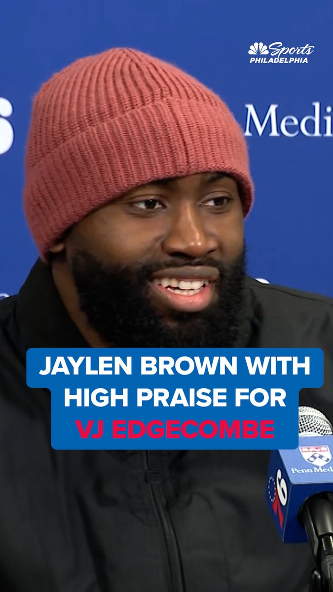 Jaylen Brown, wearing a pink beanie, speaks at a Penn Medicine press conference, with on-screen text reading "JAYLEN BROWN WITH HIGH PRAISE FOR VJ EDGECOMBE." The image relates to the accompanying post by visually highlighting Brown's quote about his admiration for the rookie Edgecombe, reinforcing the video's theme of Brown's glowing endorsement of his new teammate.