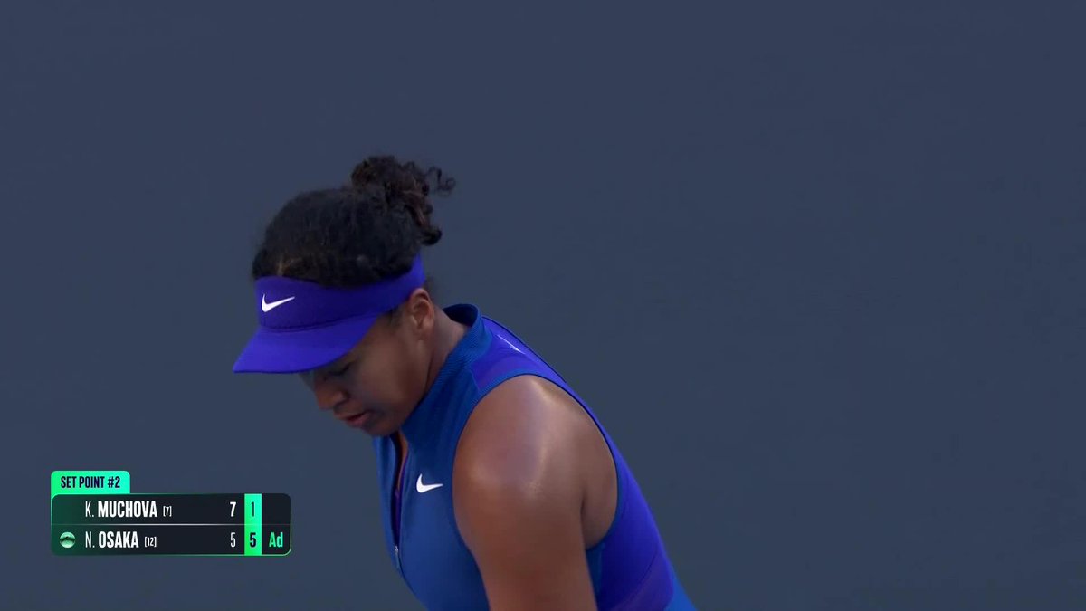Naomi Osaka, wearing a blue Nike visor and top, looks down during her match against K. Muchova at the China Open, with the scoreboard showing Muchova leading 7-1, 5-6 with Osaka at advantage, indicating a closely contested second set that went to a deciding set.